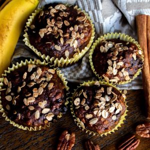 Close-up view of freshly baked banana cupcakes topped with oats, perfect for breakfast or snack.