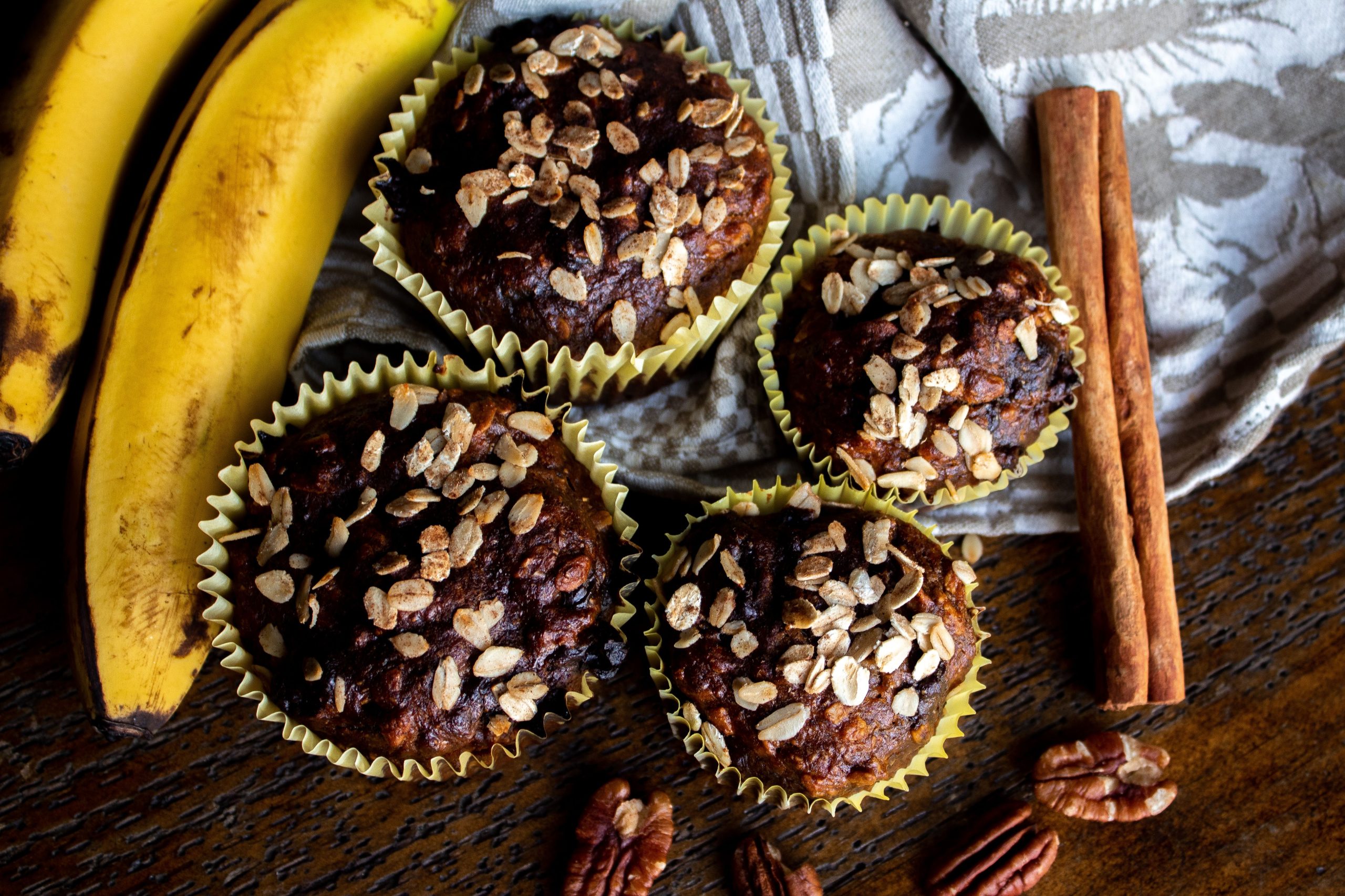 pexels photo 11615357 11615357 Close-up view of freshly baked banana cupcakes topped with oats, perfect for breakfast or snack.