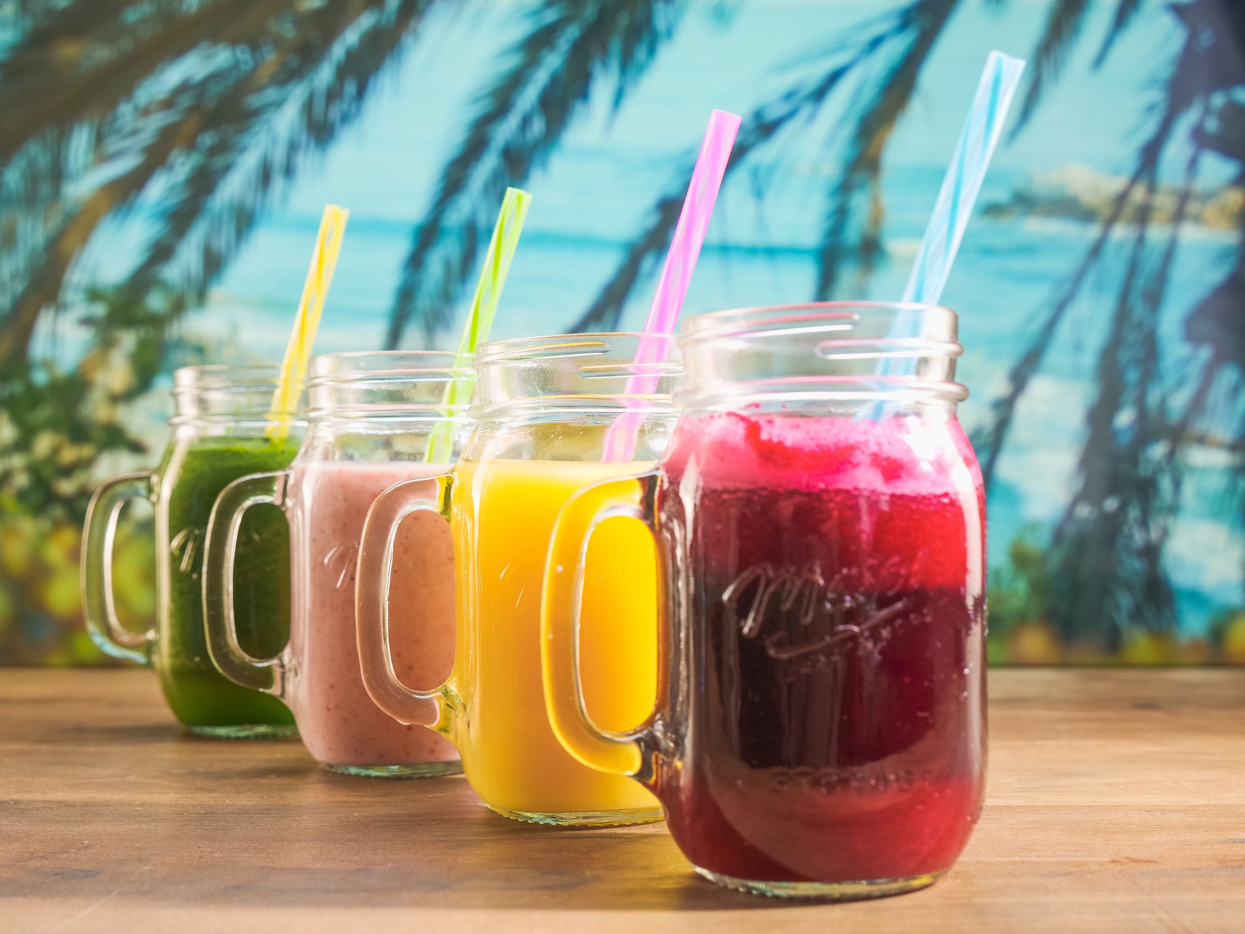 pexels photo 8181545 8181545 Vibrant fruit juices in mason jars with colorful straws, perfect for a summer refreshment.