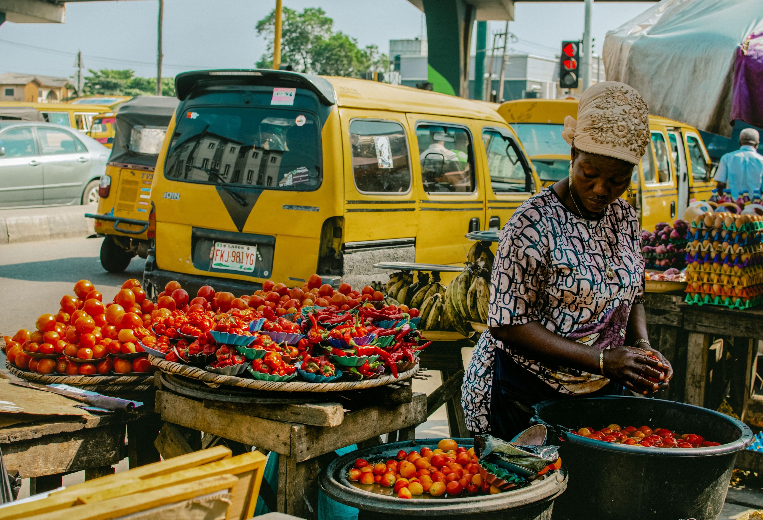 A vibrant scene of a local vendor selling fresh produce at a street market in Lagos, Nigeria.